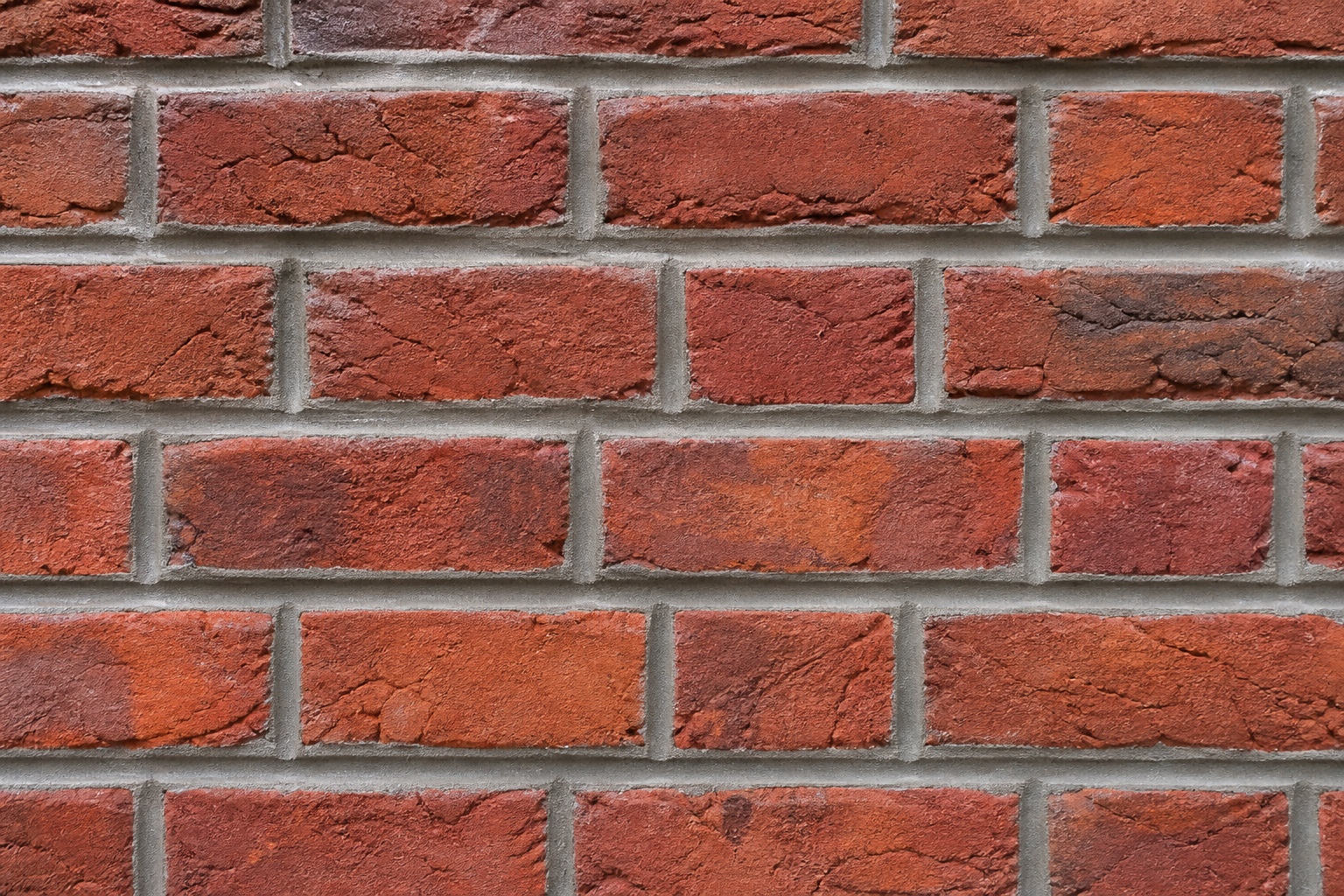 Finished red brick wall with tight, even mortar joints